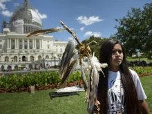 An activist protests on Capitol Hill on July 22, 2015, in Washington, D.C. Members of the San Carlos Apache Nation and other activists gathered to protest the a section of the National Defense Authorization Act that would turn over parts of Oak Flat that are sacred to the Apache to a foreign copper mining company.