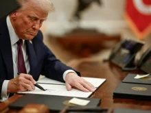 President Donald Trump signs executive orders in the Oval Office of the White House.